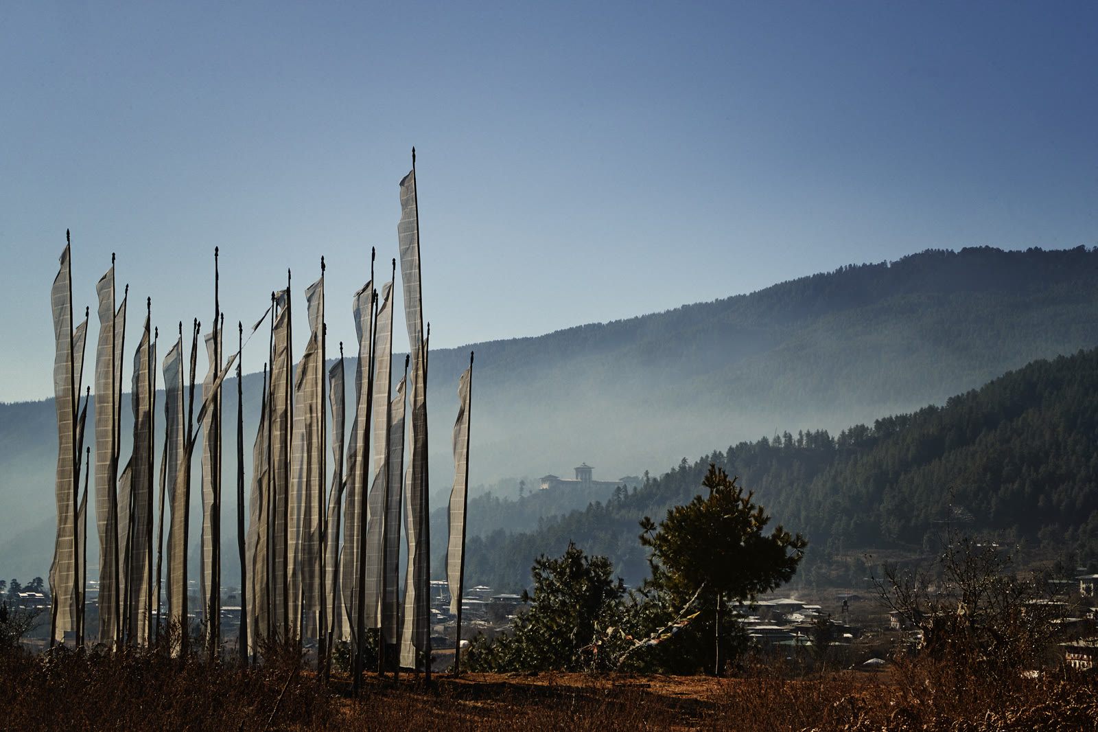 Prayer flags and the Jakar Dzong above the Bumthang Valley, Bhutan