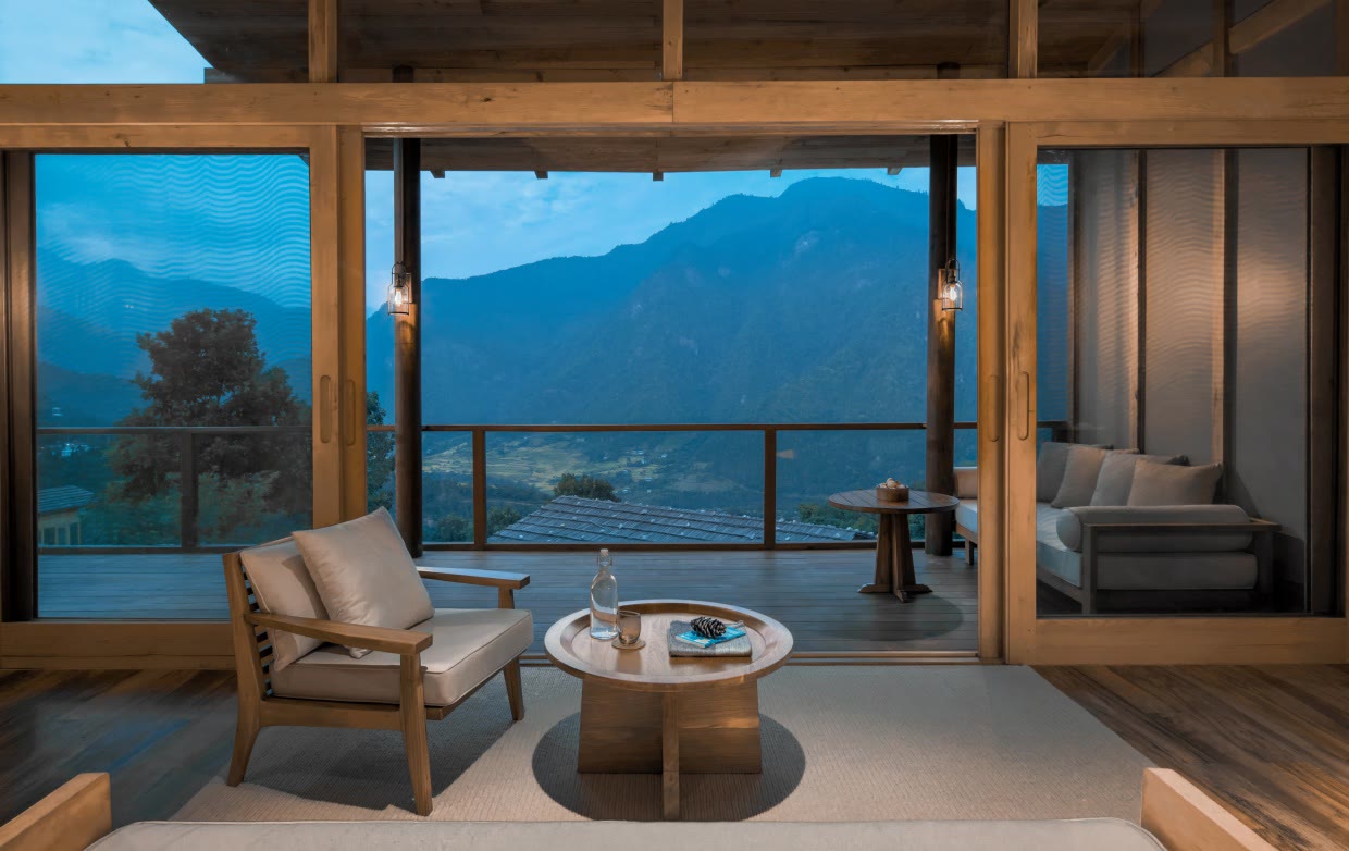 The living room and terrace of a Lodge Suite at Six Senses Punakha, Bhutan