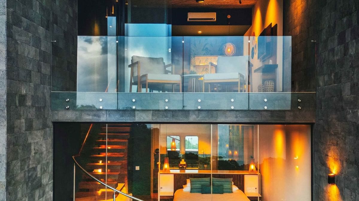 The two-story glass Townhouse at Los Altos Resort at dusk