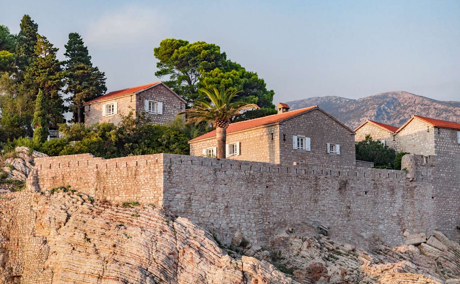 The walled island village of Aman Sveti Stefan at golden hour