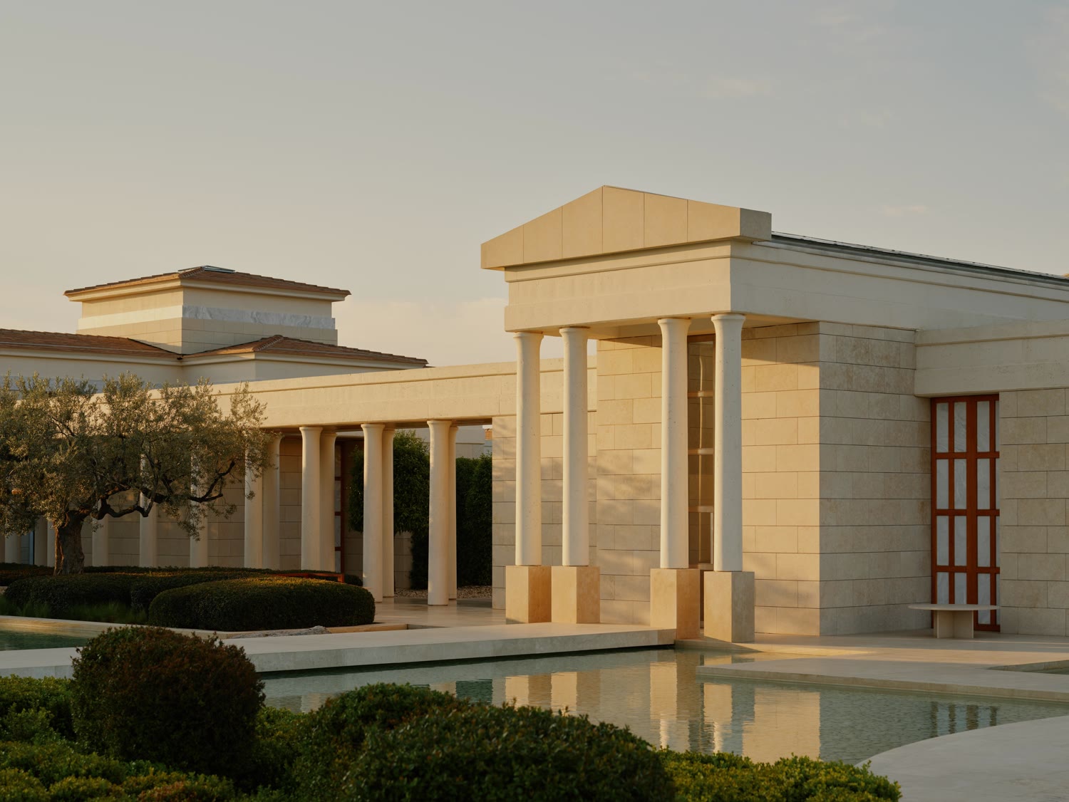 The neoclassical columns of Amanzoe at golden hour