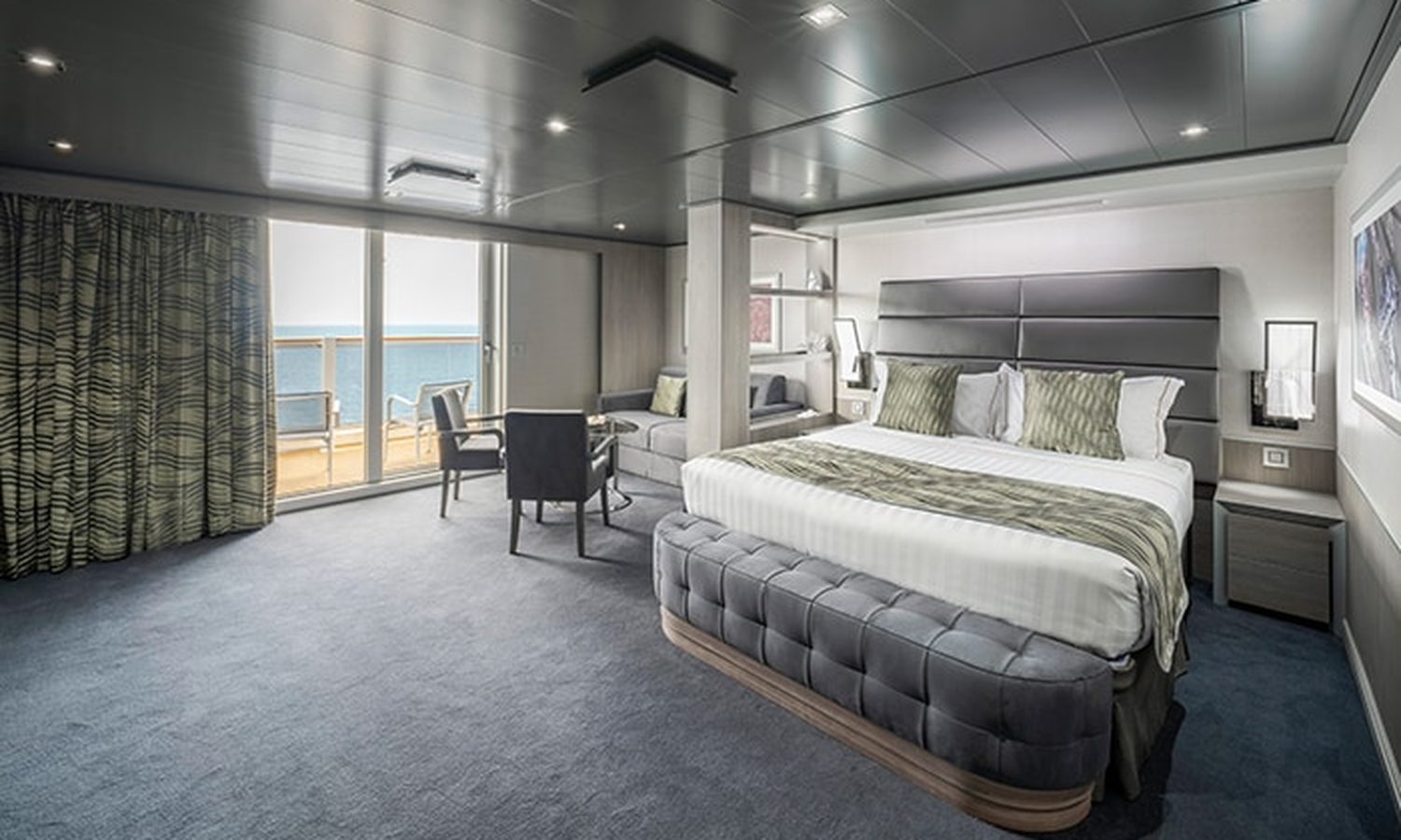 MSC Yacht Club Deluxe Suite bedroom with balcony and sea view