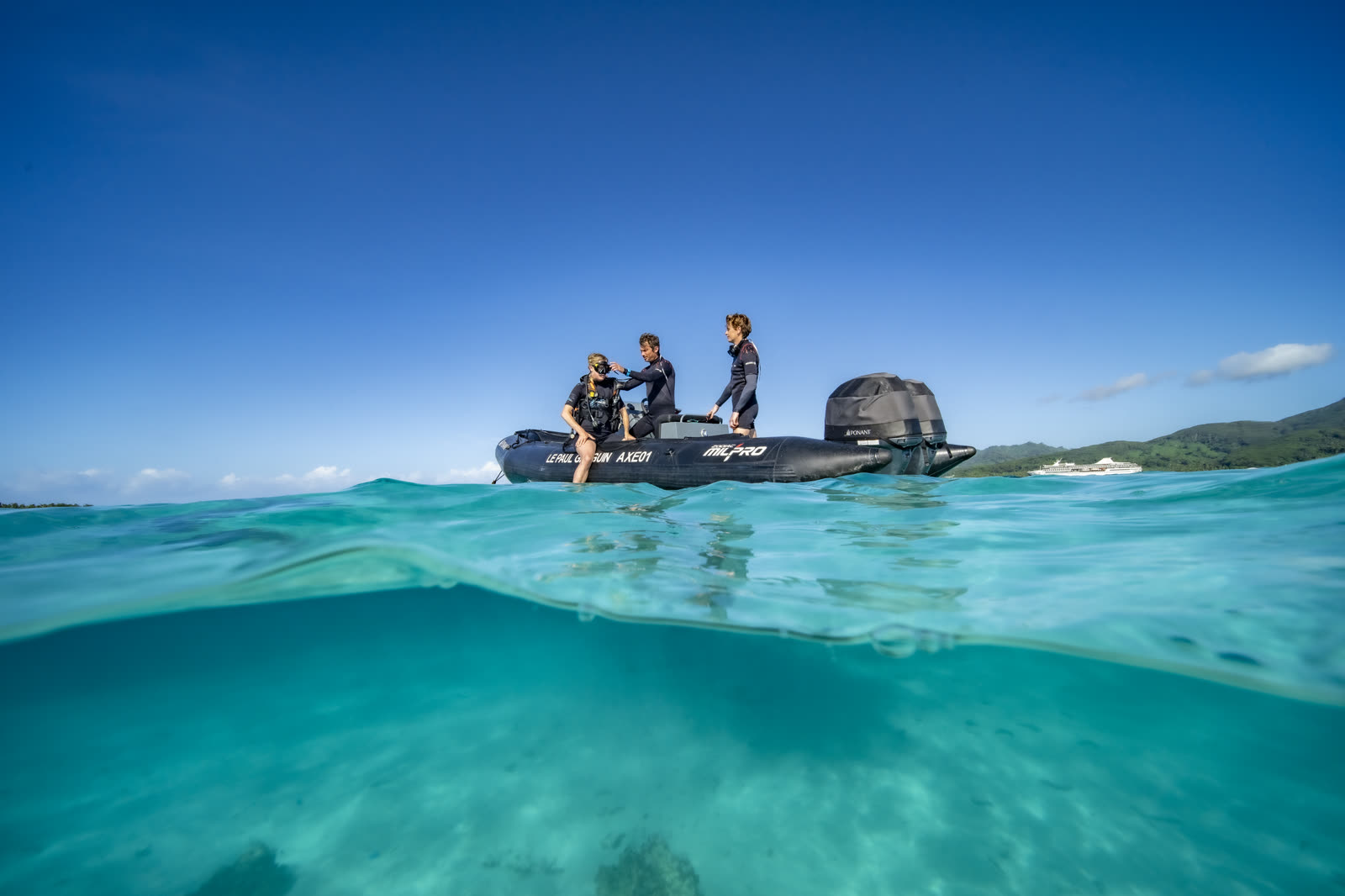 Divers setting out from the ship across a Bora Bora lagoon