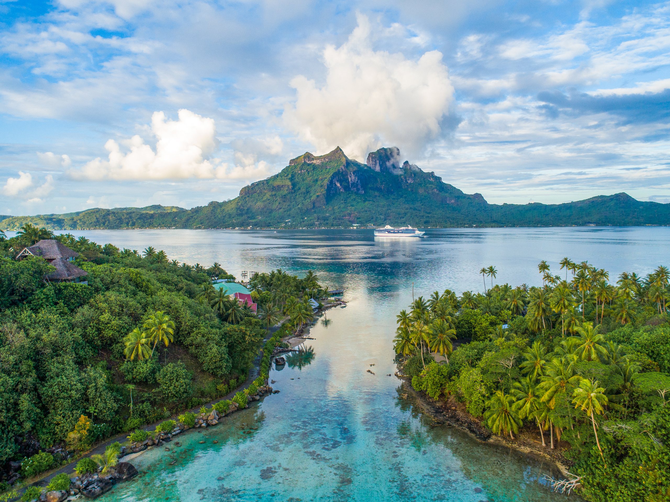 Mount Otemanu rising above the lagoon at Bora Bora, a ship at anchor