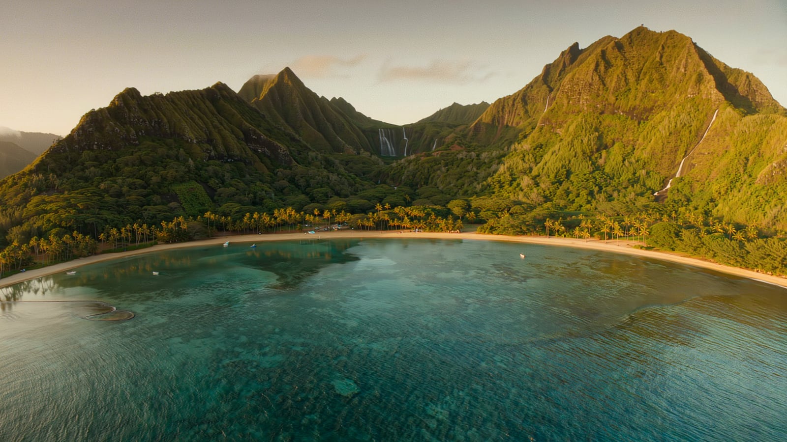Hanalei Bay and the green waterfall-laced mountains of the north shore of Kauai