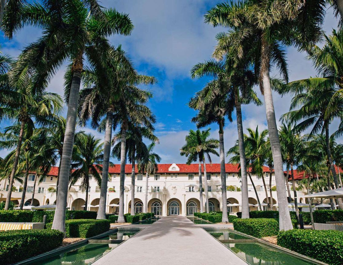 The palm-lined facade and reflecting pools of Casa Marina, Key West
