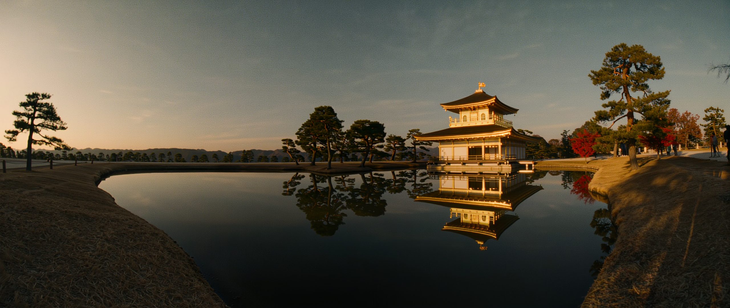 The Golden Pavilion of Kinkaku-ji reflected in its pond at golden hour, Kyoto