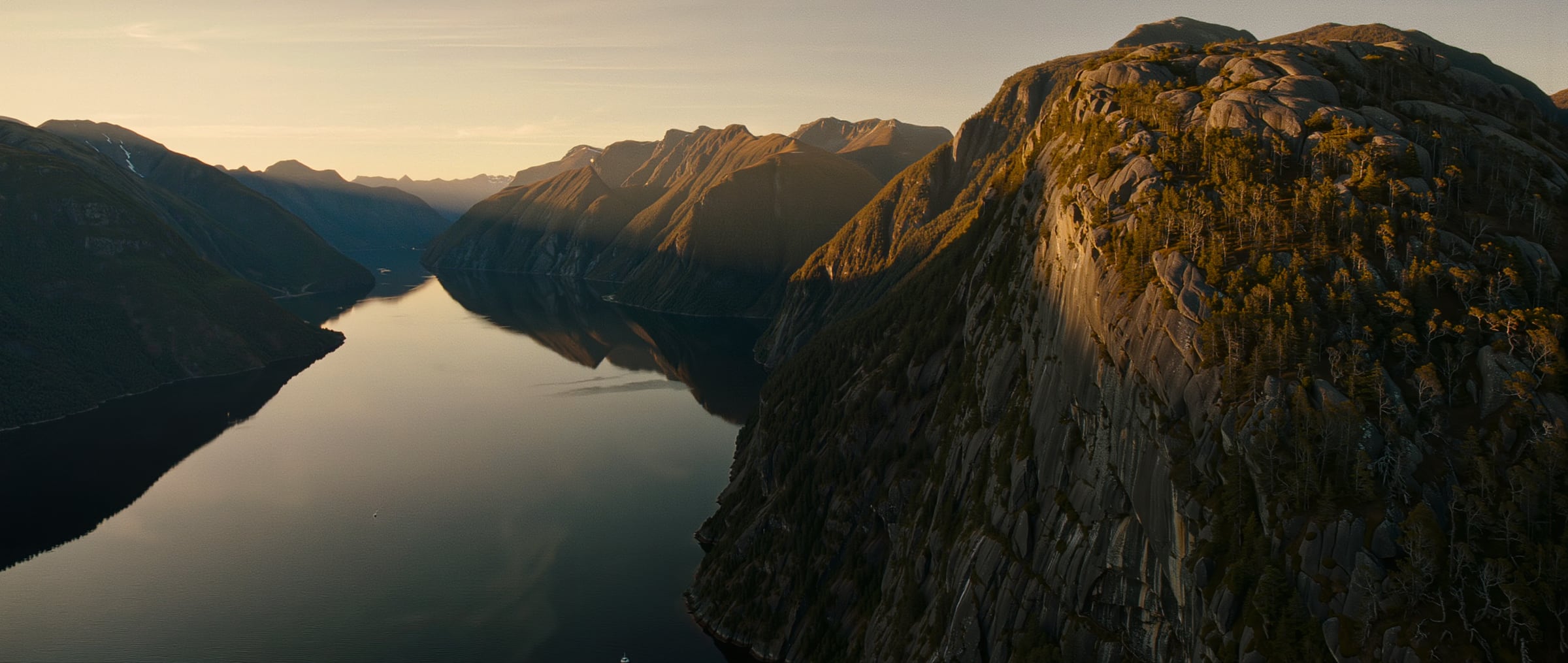 A Patagonian fjord in southern Chile, forested mountains rising from still water