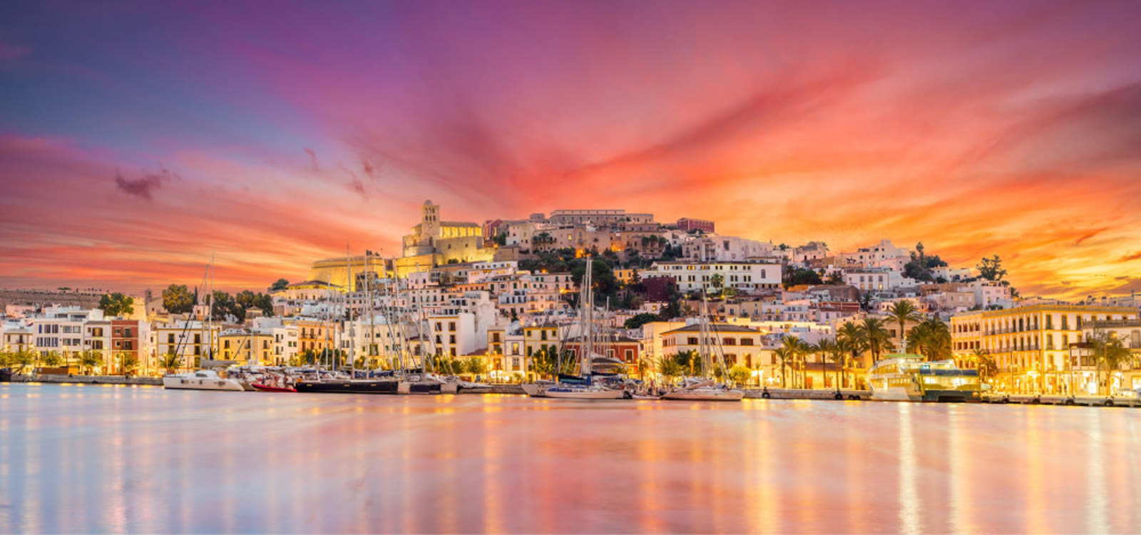 The harbor and coast of Ibiza at sunset