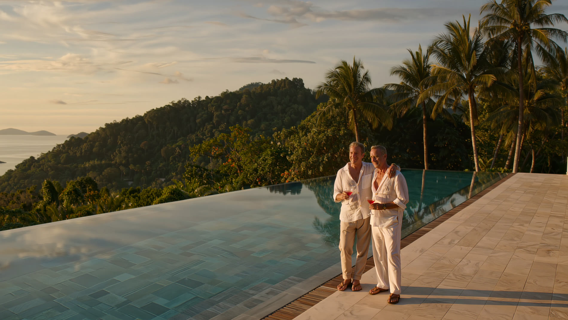 A couple at a hillside infinity pool above the Andaman Sea, Phuket